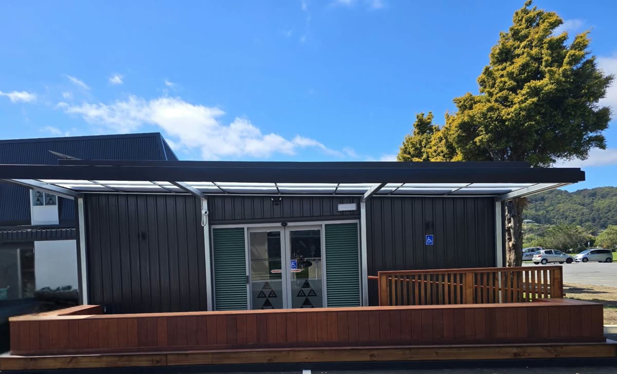 The Waiwaka laundromat building, with its timber deck and covered entrance